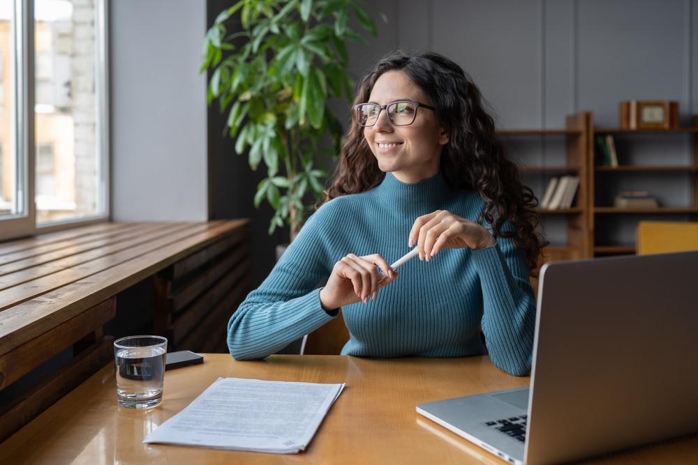 Positive happy female employee resting at workplace